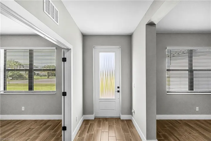 Foyer entrance with wood tiled floors and baseboards