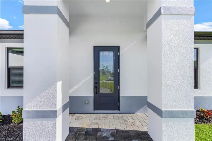 Property entrance featuring stucco siding