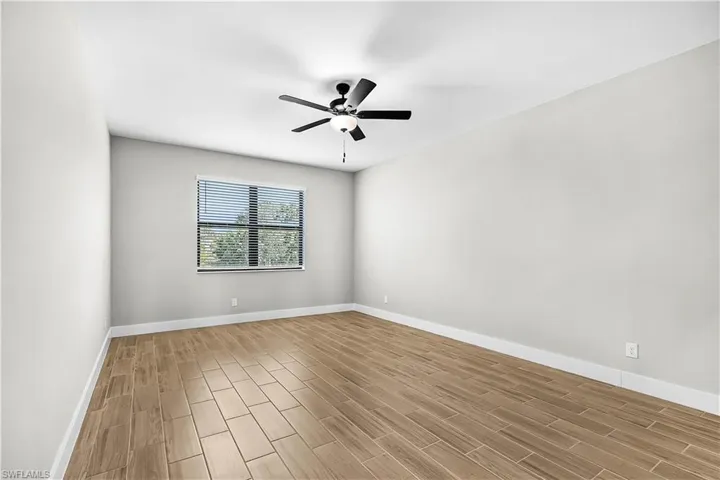 Spare room with wood tiled floors and a ceiling fan