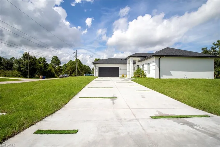 View of front of home featuring a front yard and a garage