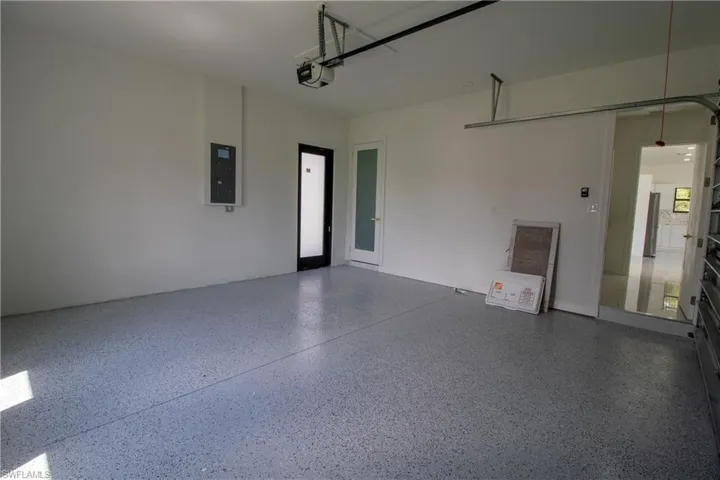 Garage with a garage door opener and electric panel