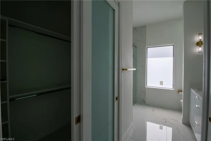 Bathroom featuring toilet, tile patterned floors, and vanity