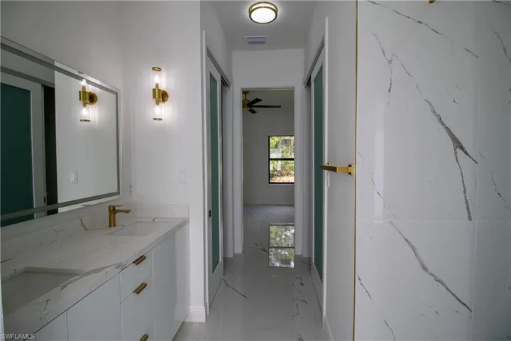 Bathroom featuring tile patterned flooring and dual vanity