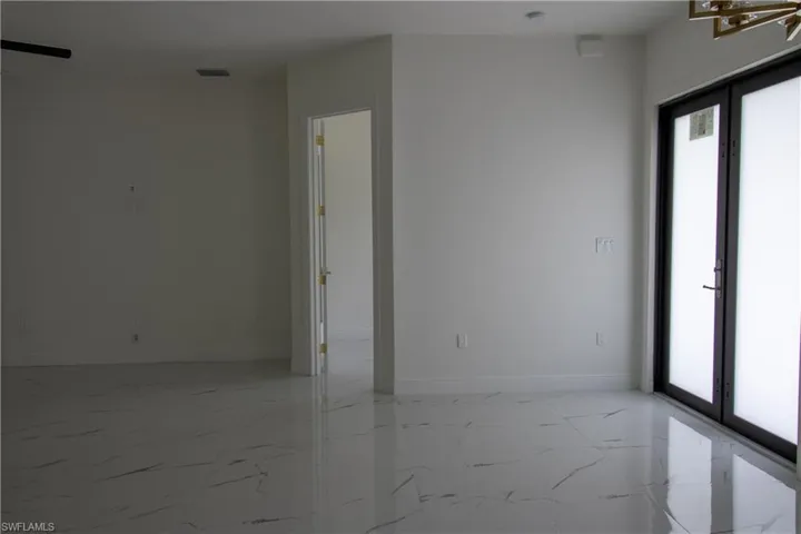 Tiled empty room featuring a healthy amount of sunlight