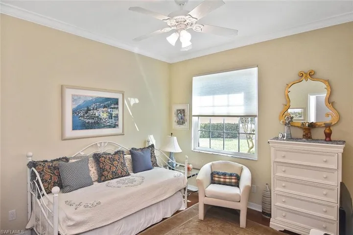 Bedroom with ceiling fan, baseboards, and crown molding