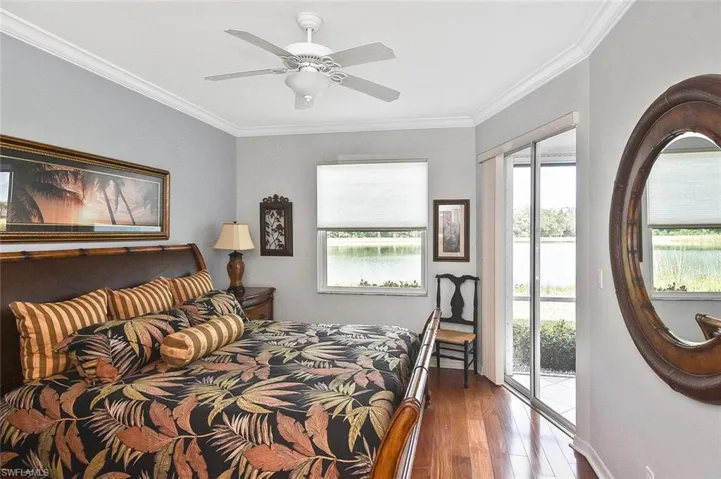 Bedroom with hardwood / wood-style floors, crown molding, a ceiling fan, and access to outside