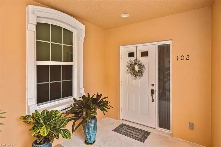 View of exterior entry featuring stucco siding