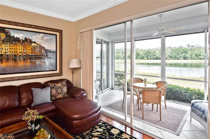 Living area featuring ornamental molding, a water view, and ceiling fan