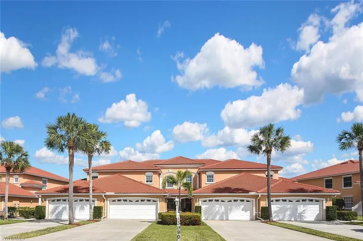 Mediterranean / spanish house with stucco siding, a tile roof, and concrete driveway