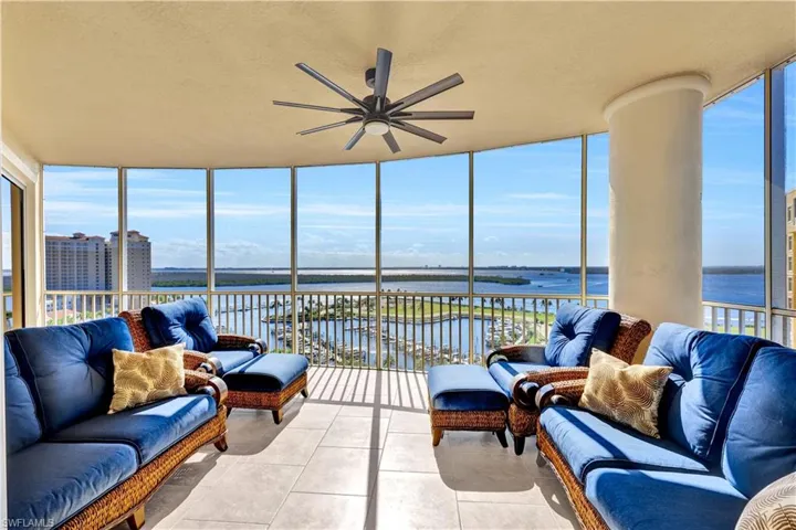 Sunroom / solarium featuring a water view and ceiling fan