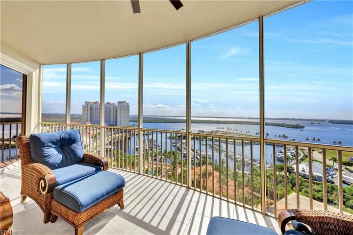 Sunroom / solarium featuring a water view and ceiling fan