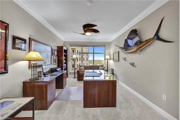 Office area with crown molding, light colored carpet, and ceiling fan