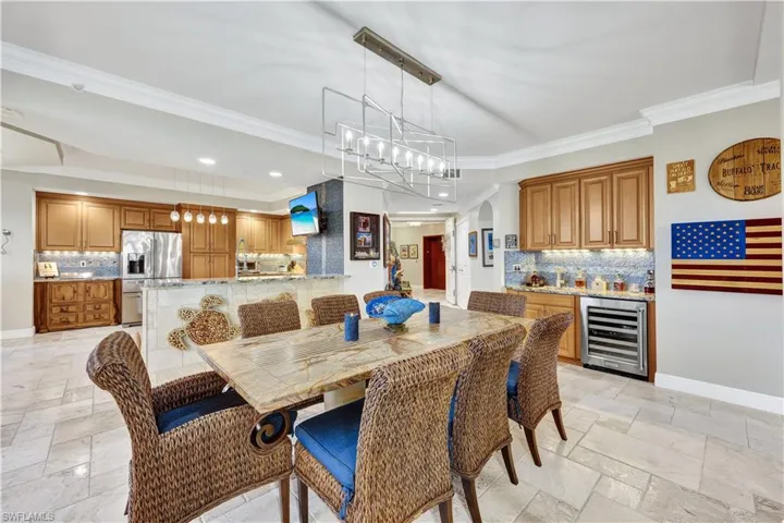 Dining area with ornamental molding and beverage cooler