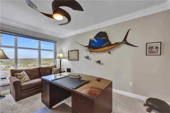 Office area featuring crown molding, light colored carpet, and ceiling fan