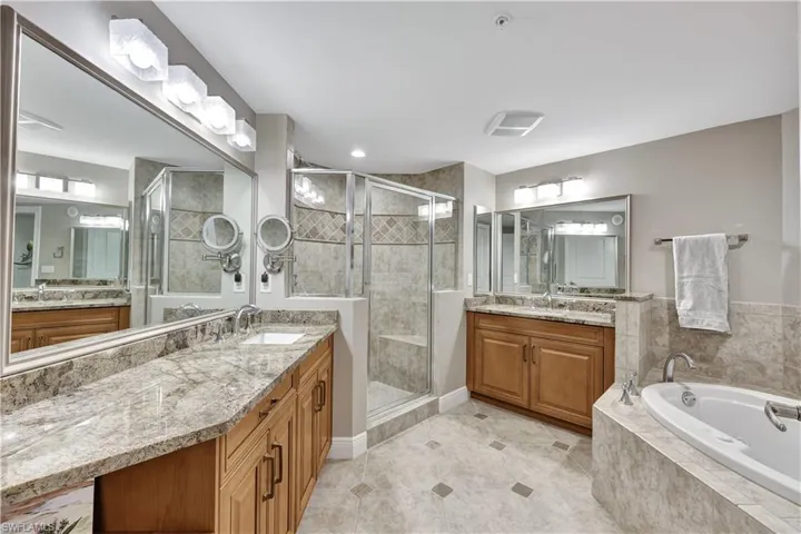 Bathroom with vanity, independent shower and bath, and tile patterned flooring