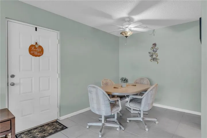Tiled dining space with ceiling fan - same tile throughout