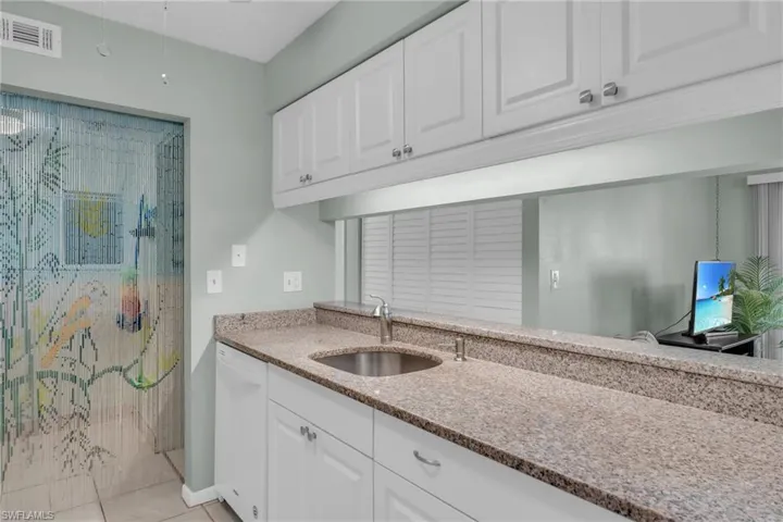 Kitchen with white cabinets, dishwasher
