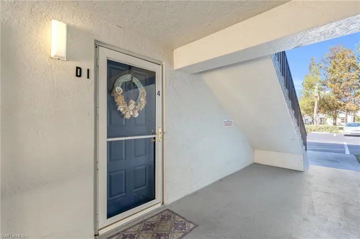 View of exterior entry with screen door.