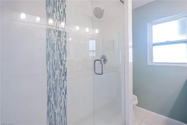 Renovated coastal theme tiled shower