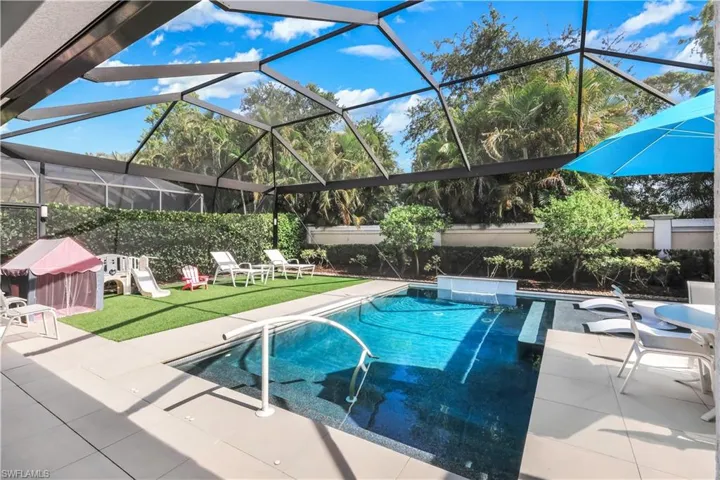 Fabulous lanai with under cover area, large pool, lounge area, electric hurricane screens and built-in kitchen (not shown).