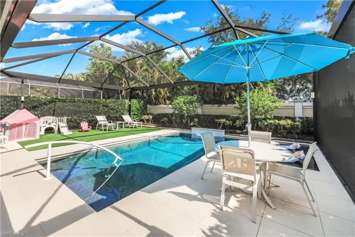 Fabulous lanai with under cover area, large pool, lounge area, electric hurricane screens and built-in kitchen (not shown).