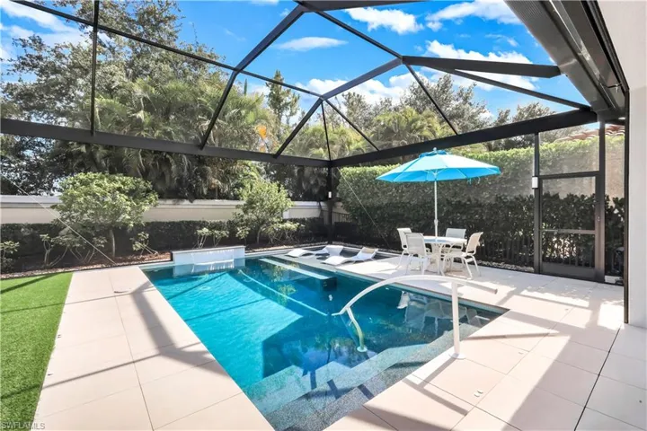 Fabulous lanai with under cover area, large pool, lounge area, electric hurricane screens and built-in kitchen (not shown).