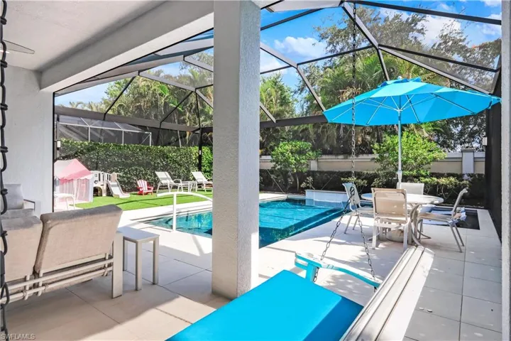 Fabulous lanai with under cover area, large pool, lounge area, electric hurricane screens and built-in kitchen (not shown).