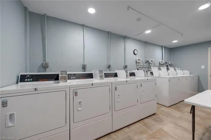 Clothes washing area featuring washing machine and dryer
