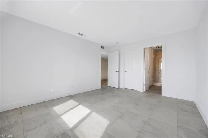 Unfurnished bedroom with ensuite bathroom