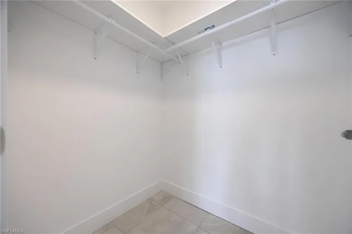 Spacious closet featuring light tile patterned floors