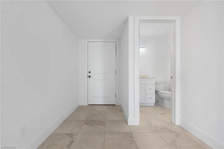 Hallway with light tile patterned floors