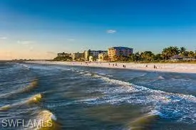Beach on opposite side of street at sunset