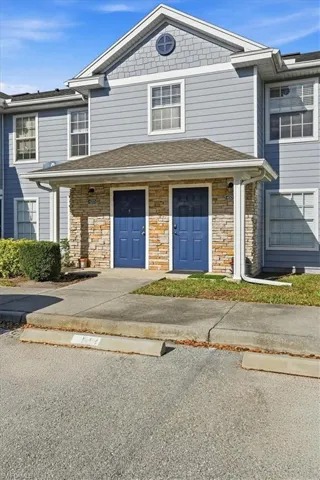 Traditional home with stone siding and uncovered parking