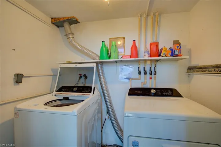 Community Laundry area with washing machine and clothes dryer