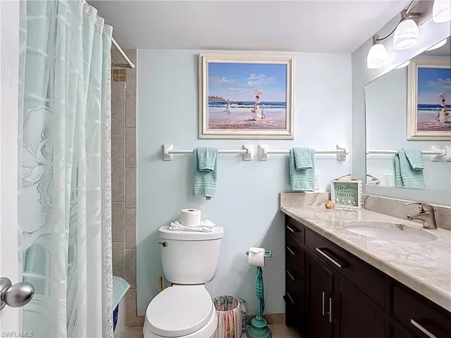 Full bath with vanity and curtained shower