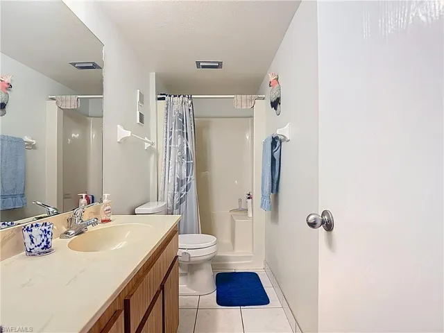 Master Bathroom featuring vanity, a shower with shower curtain, and light tile patterned floors