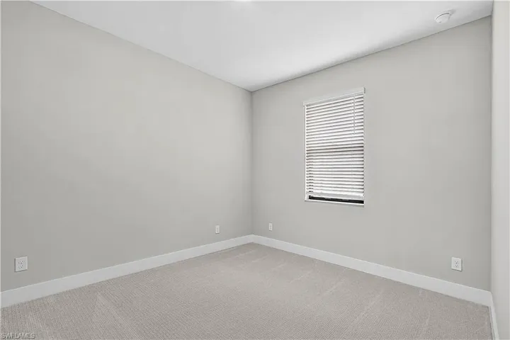 Empty room with carpet flooring and baseboards