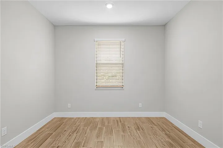 Empty room with baseboards and light wood finished floors