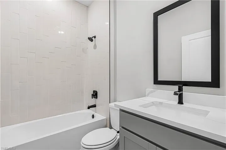 Bathroom with vanity and tub / shower combination