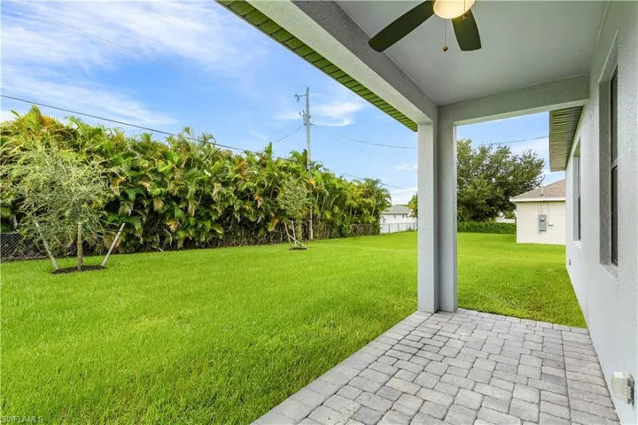 Fenced backyard with a patio area and a ceiling fan