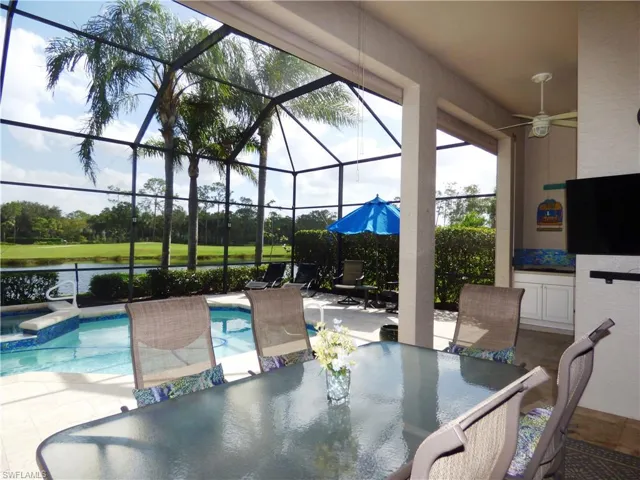 View of swimming pool with golf course view.