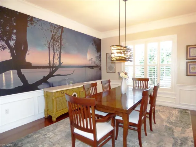 Dining area featuring wood flooring and crown molding