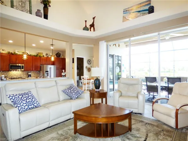 Tiled living room with a high ceiling.
