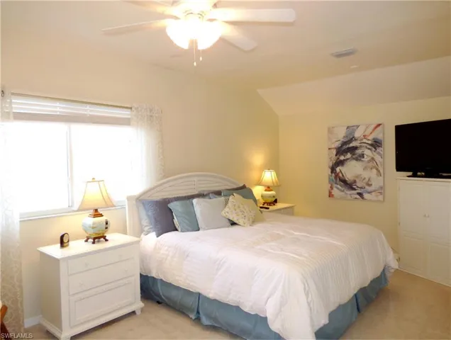 Expanded Guest Bedroom featuring vaulted ceiling and ceiling fan.