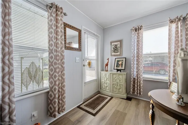 Foyer entrance with light wood-type flooring and baseboards