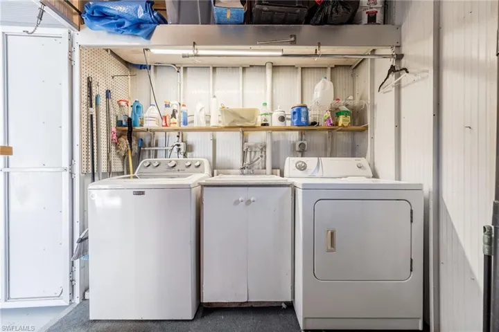Laundry room with separate washer and dryer and a sink
