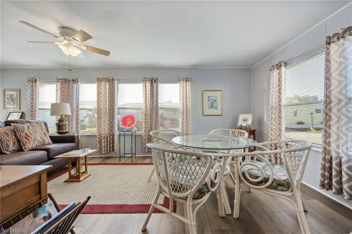 Dining area featuring wood finished floors, plenty of natural light, and a ceiling fan