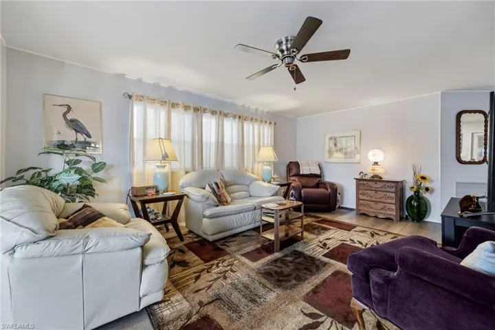 Living area with wood finished floors and a ceiling fan