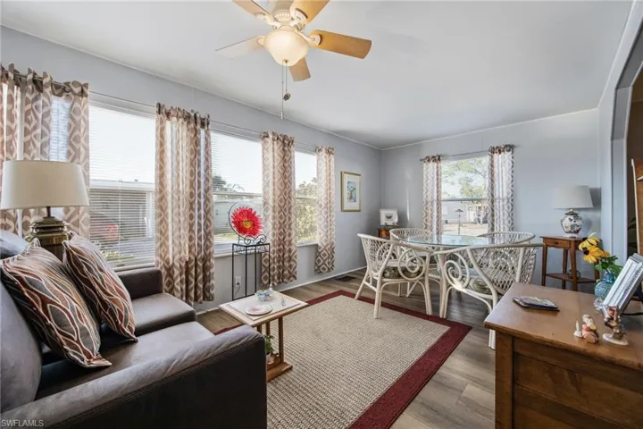 Living area featuring wood finished floors and a ceiling fan