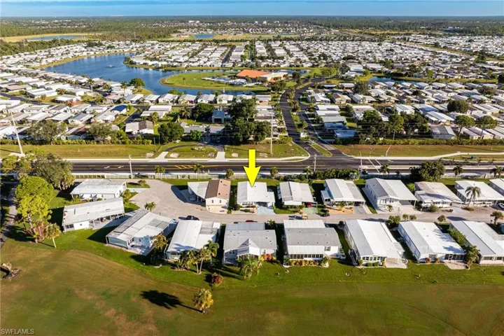 Aerial view of property's location with nearby suburban area and a nearby body of water